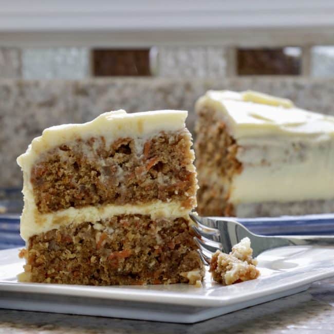 a piece of carrot cake with a fork on a plate