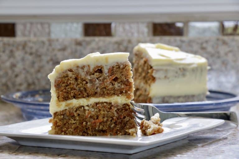 a piece of carrot cake with a fork on a plate